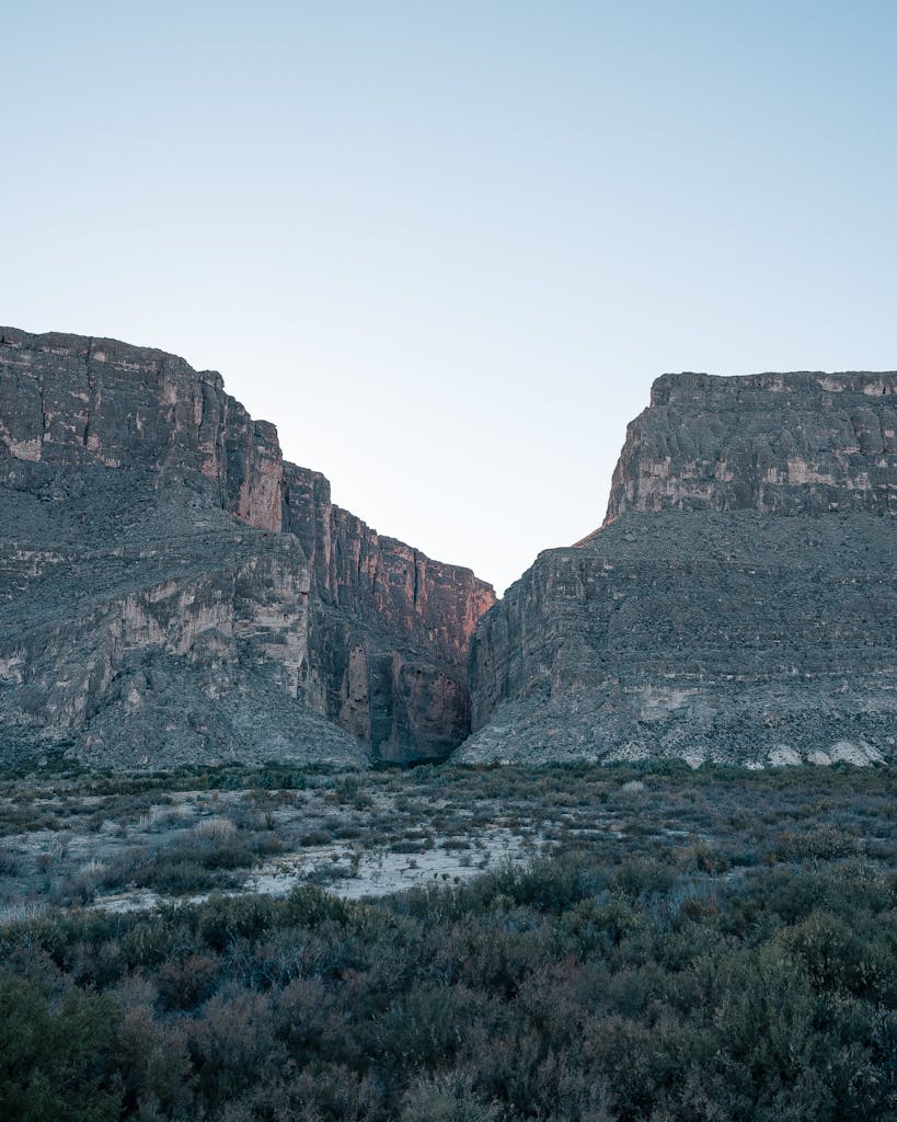 A dramatic view of Big Bend National Park's cliffs and rock formations at dusk.