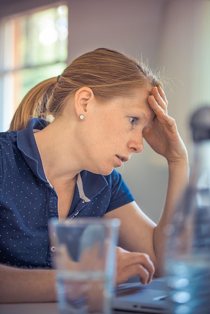 Person Sitting In Silence, Avoiding Conversation, With A Frustrated Partner Looking On