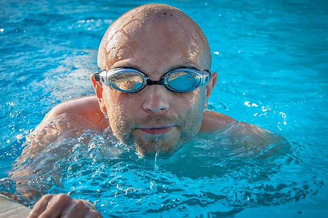 Swimming In A Pool With A Person Performing Different Strokes, Showcasing Core Rotation And Stabilization In The Water