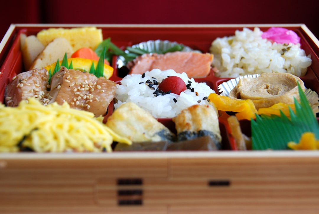 Onigiri Rice Triangles In A Bento Box With Nori Seaweed And Toppings