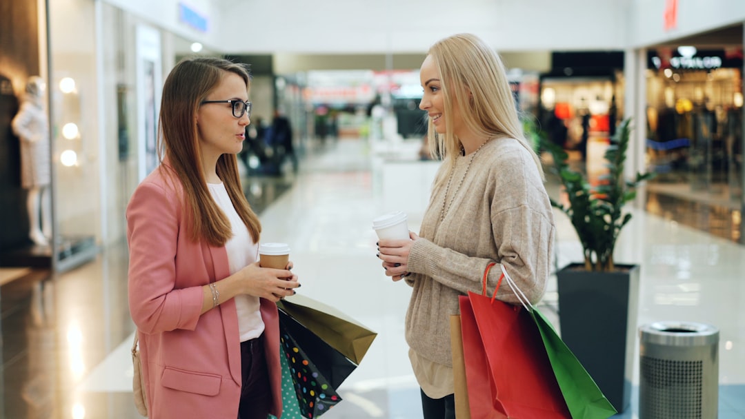 Impulse Buying In A Retail Environment With Shoppers Surrounded By Sale Signs And Products On Display
