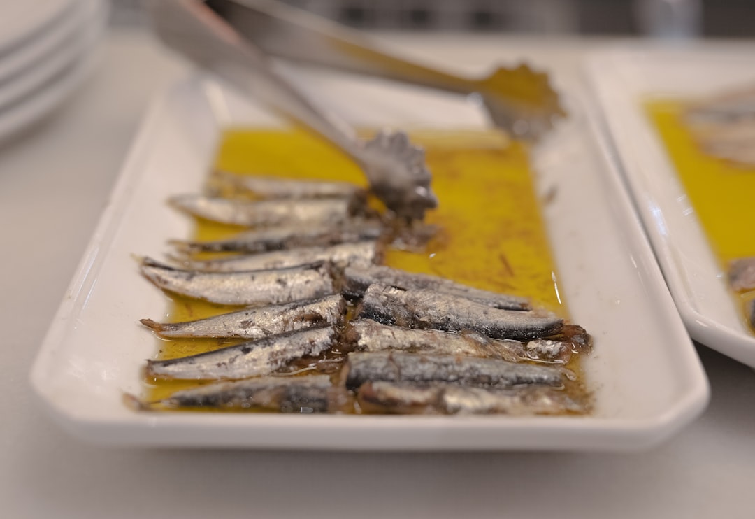 Sardines On A Plate With Fresh Herbs And Lemon Slices