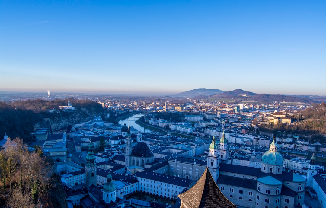 Salzburg Cityscape With Historic Architecture And Mountains In The Background