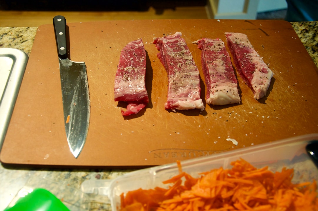 Boning Knife On A Cutting Board With Meat And Bones