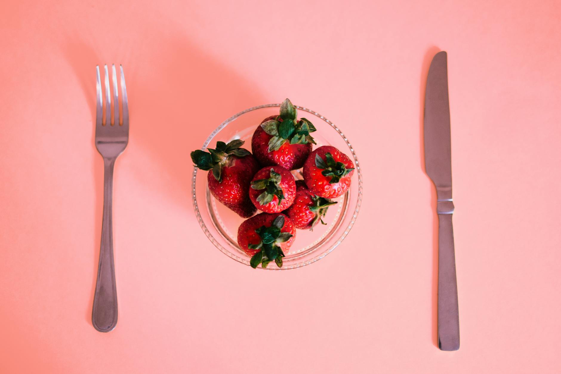 Strawberries On A Wooden Table With A Knife And A Bowl, Showcasing Their Vibrant Red Color And Fresh Appearance