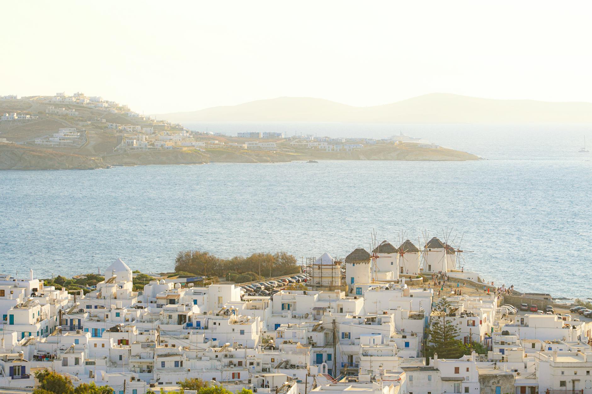 Mykonos Island With Windmills And Colorful Houses By The Sea
