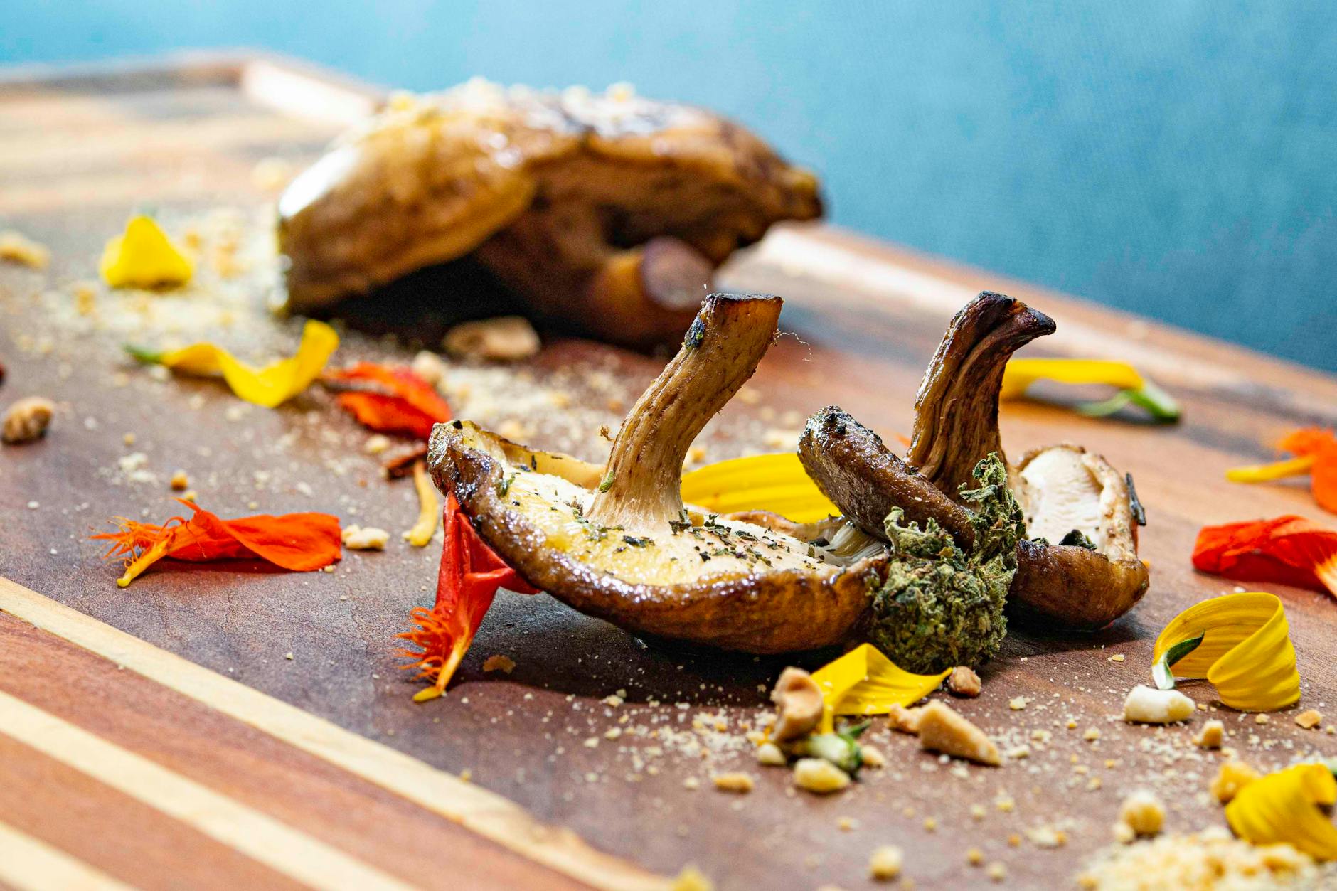 Shiitake Mushrooms On A Wooden Cutting Board With Fresh Herbs And Garlic