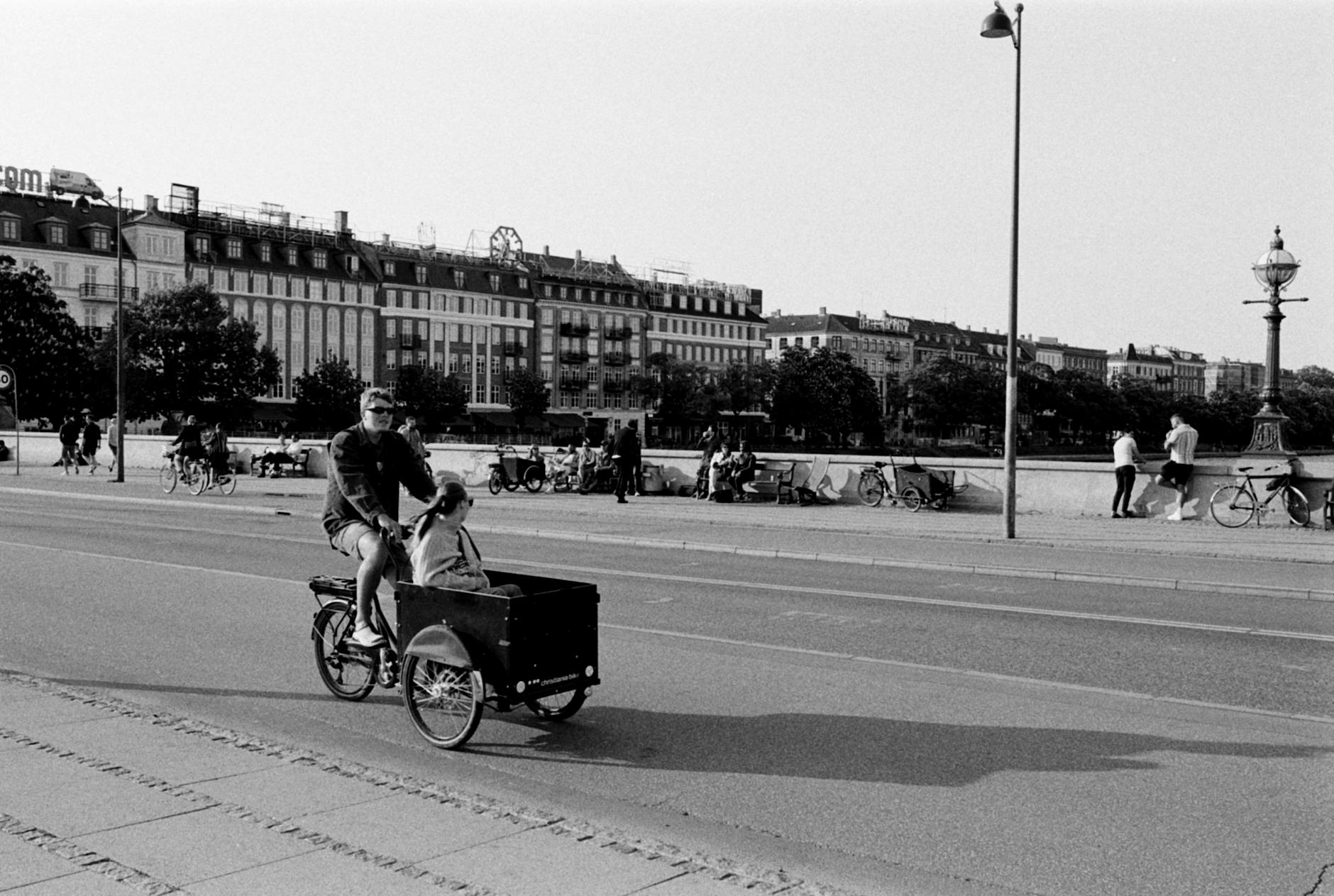 Copenhagen City Streets With Cyclists, Cafes, And Public Transport At Night