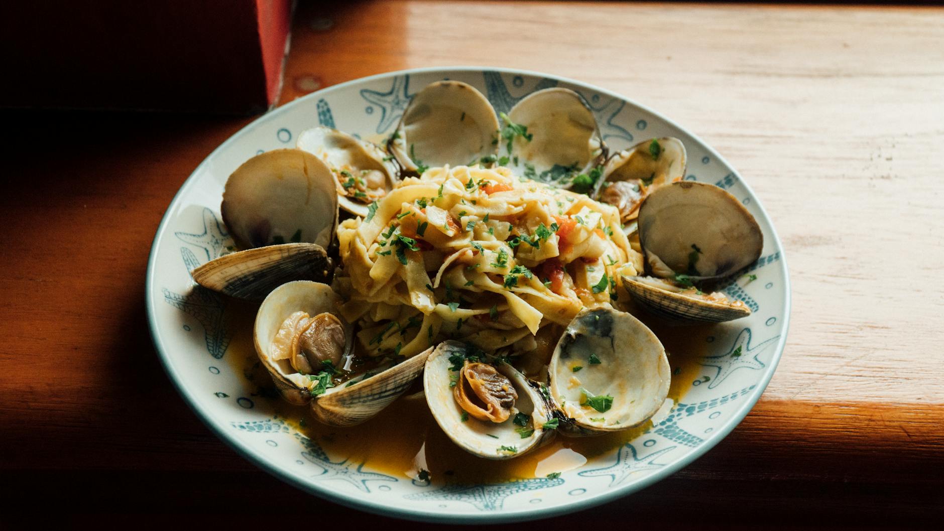 Linguine Pasta With Seafood Sauce And Clams On A Plate
