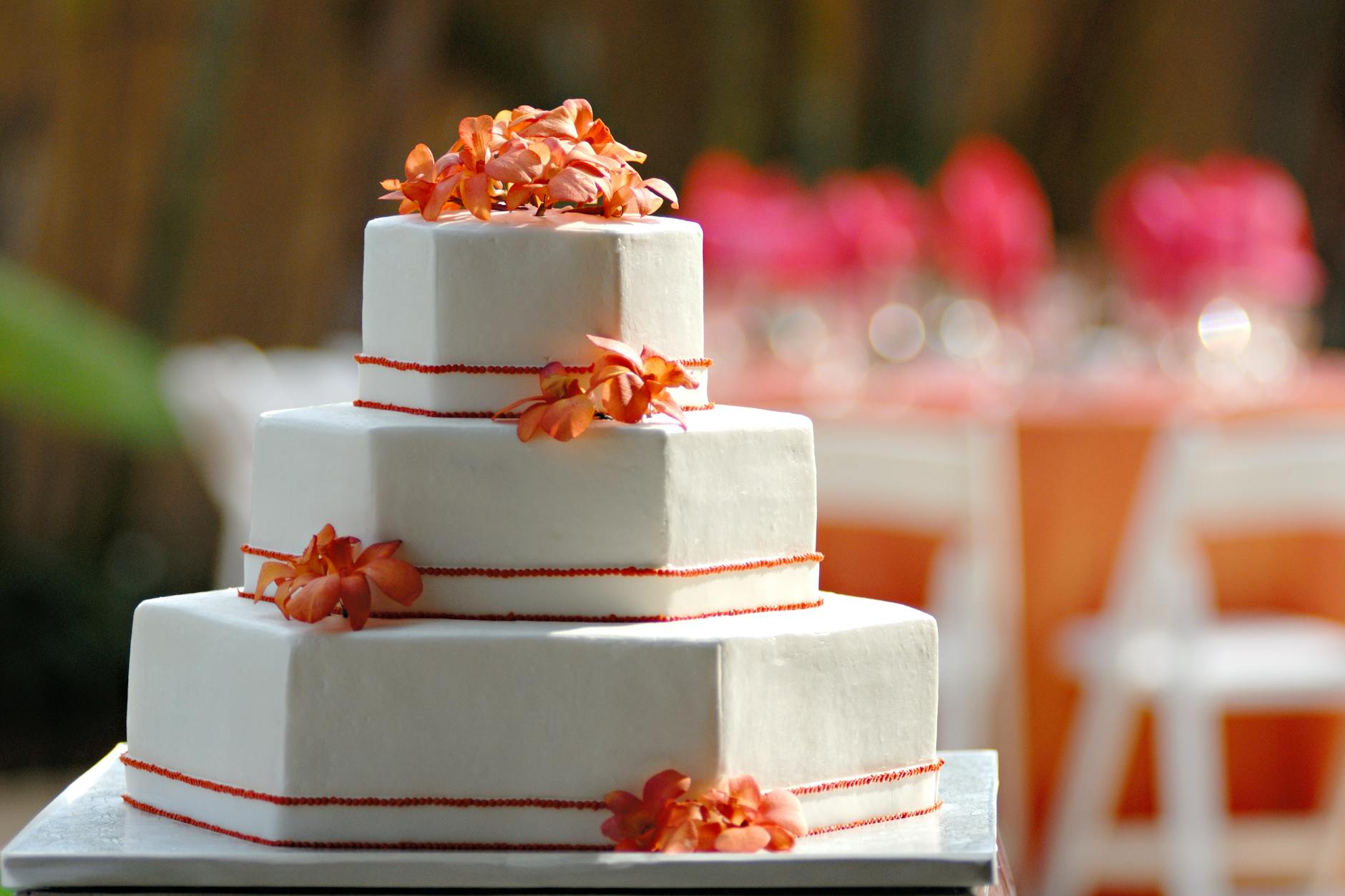Hexagon Wedding Cake Tiers With Floral Decorations And Metallic Accents