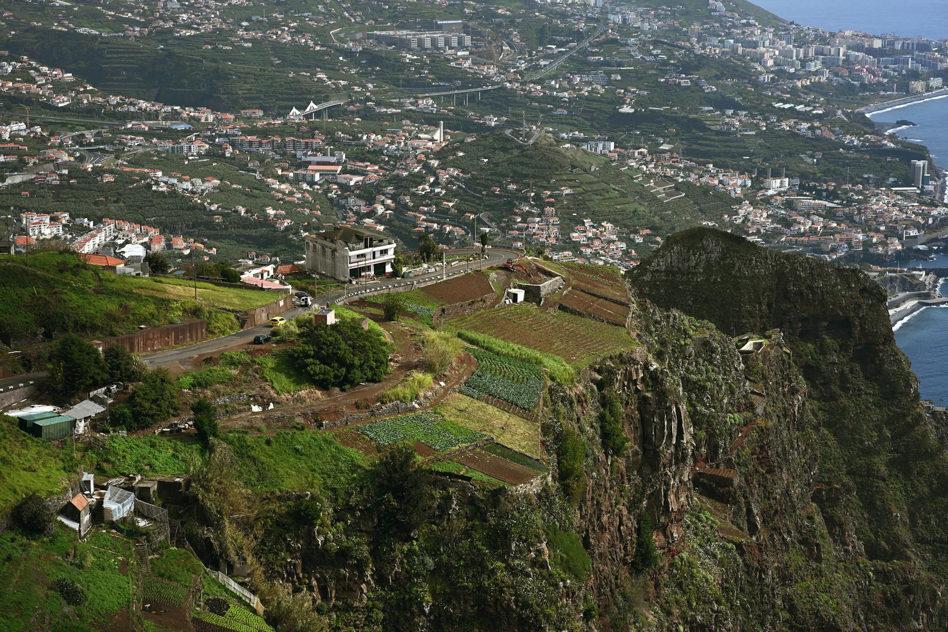 Madeira Island Landscape With Steep Terrain, Levadas, Laurel Forest, And Funchal City Views