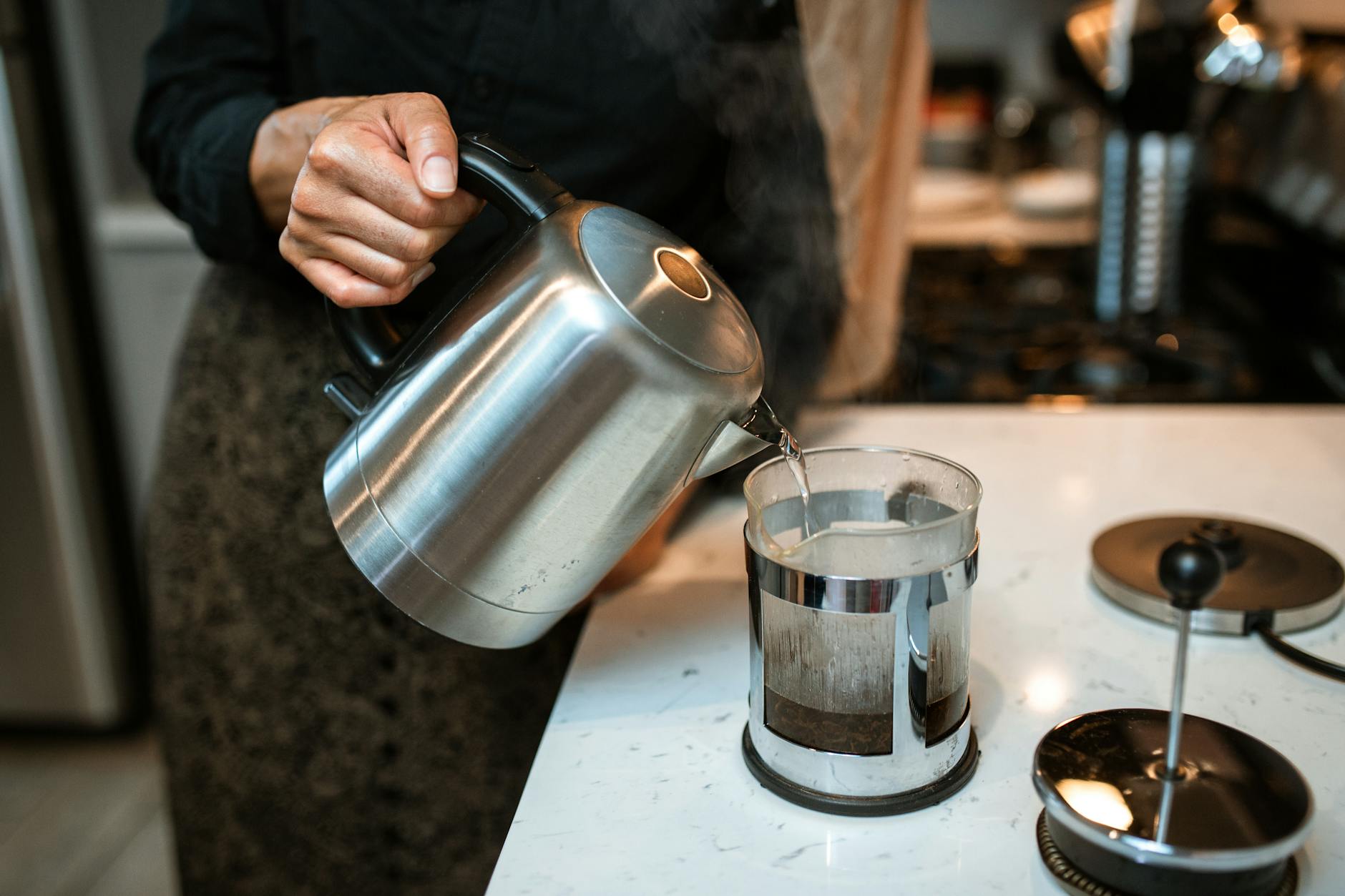 Electric Kettle On A Kitchen Counter With Steam Rising