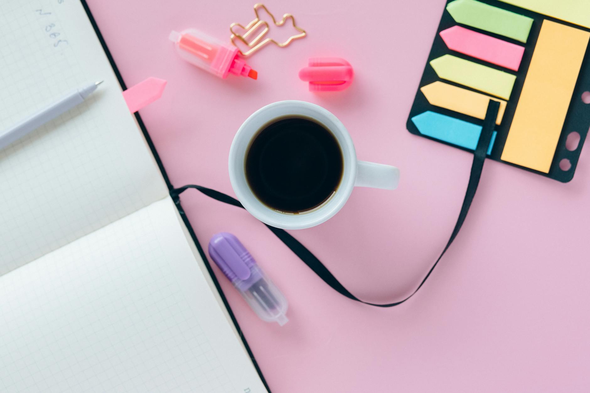 Paper Daily Planner On A Desk With A Pen, Notebook, And Coffee Cup, In A Bright And Organized Workspace