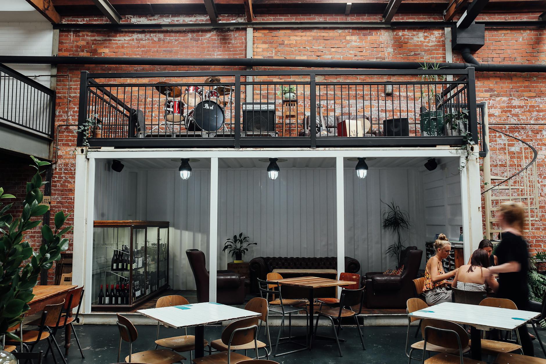 Charcoal Industrial Loft Decor With Black Metal, Leather, And Warm Wood Accents