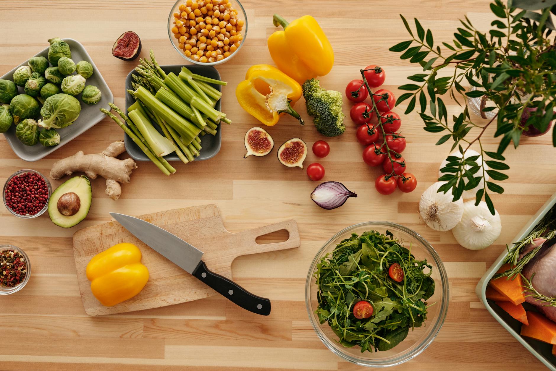 Celery Stalks On A Wooden Cutting Board With A Knife And A Small Bowl Of Dip