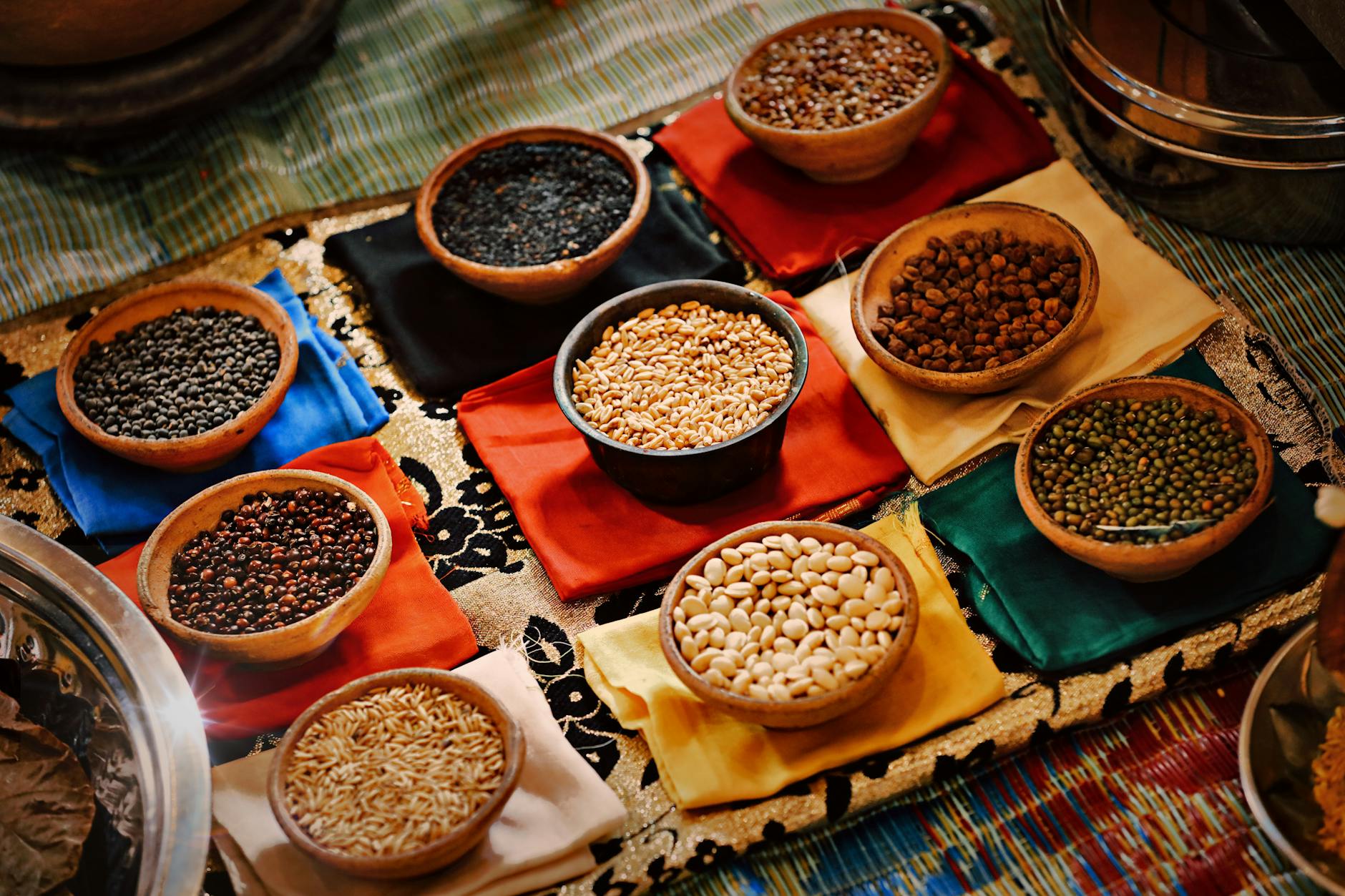 Lentils In A Bowl With Fresh Herbs And Spices, Surrounded By A Variety Of Vegetables And Grains