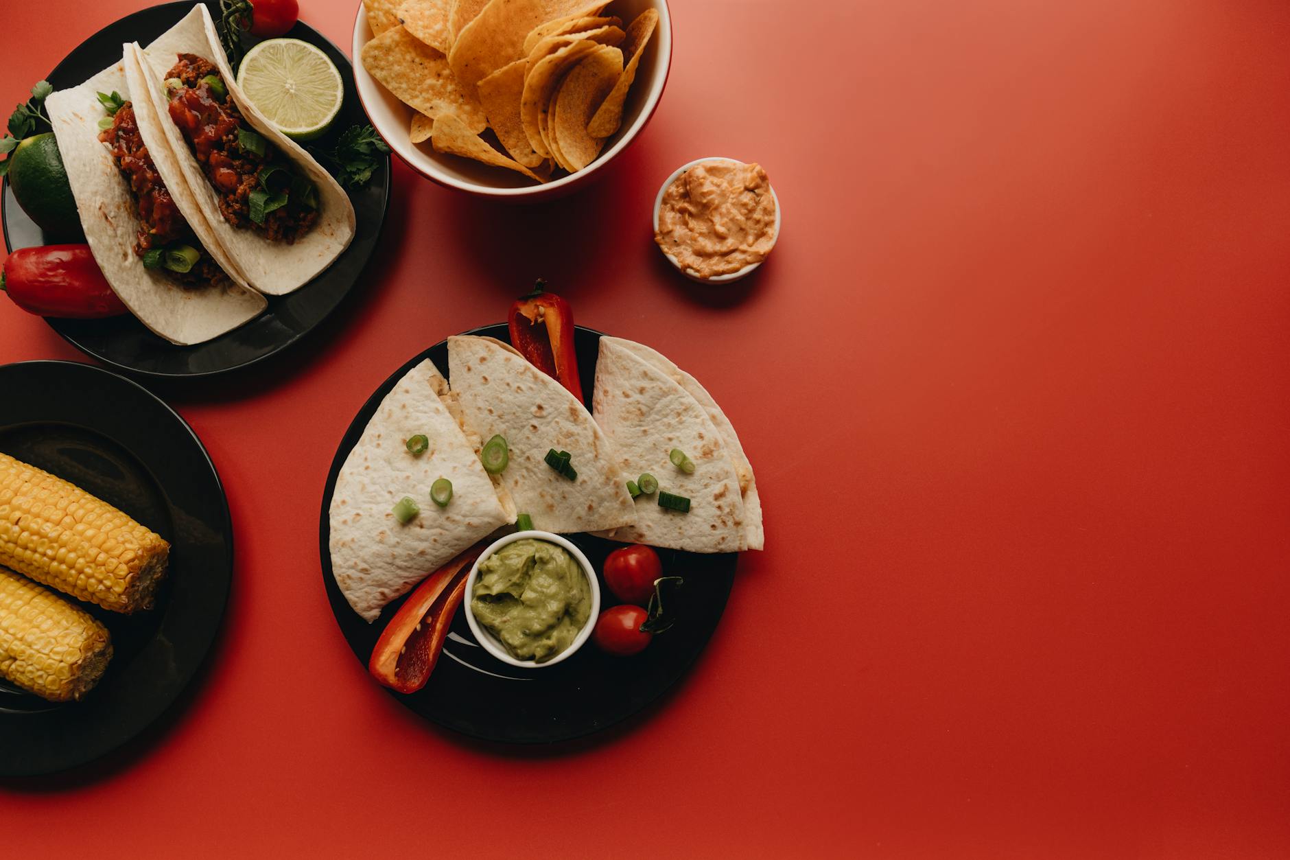 Mexican Fiesta Platter With Bowls Of Guacamole And Salsa, Colorful Tortilla Chips, Mini Quesadillas, Taquitos, Jalapeño Poppers,