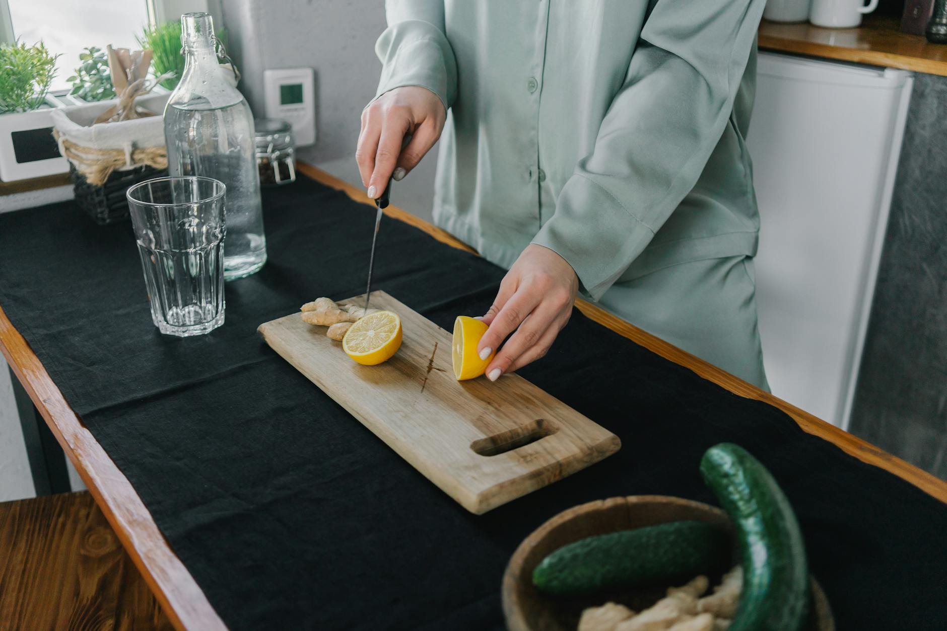 Cucumbers On A Cutting Board With Fresh Mint And A Glass Of Water