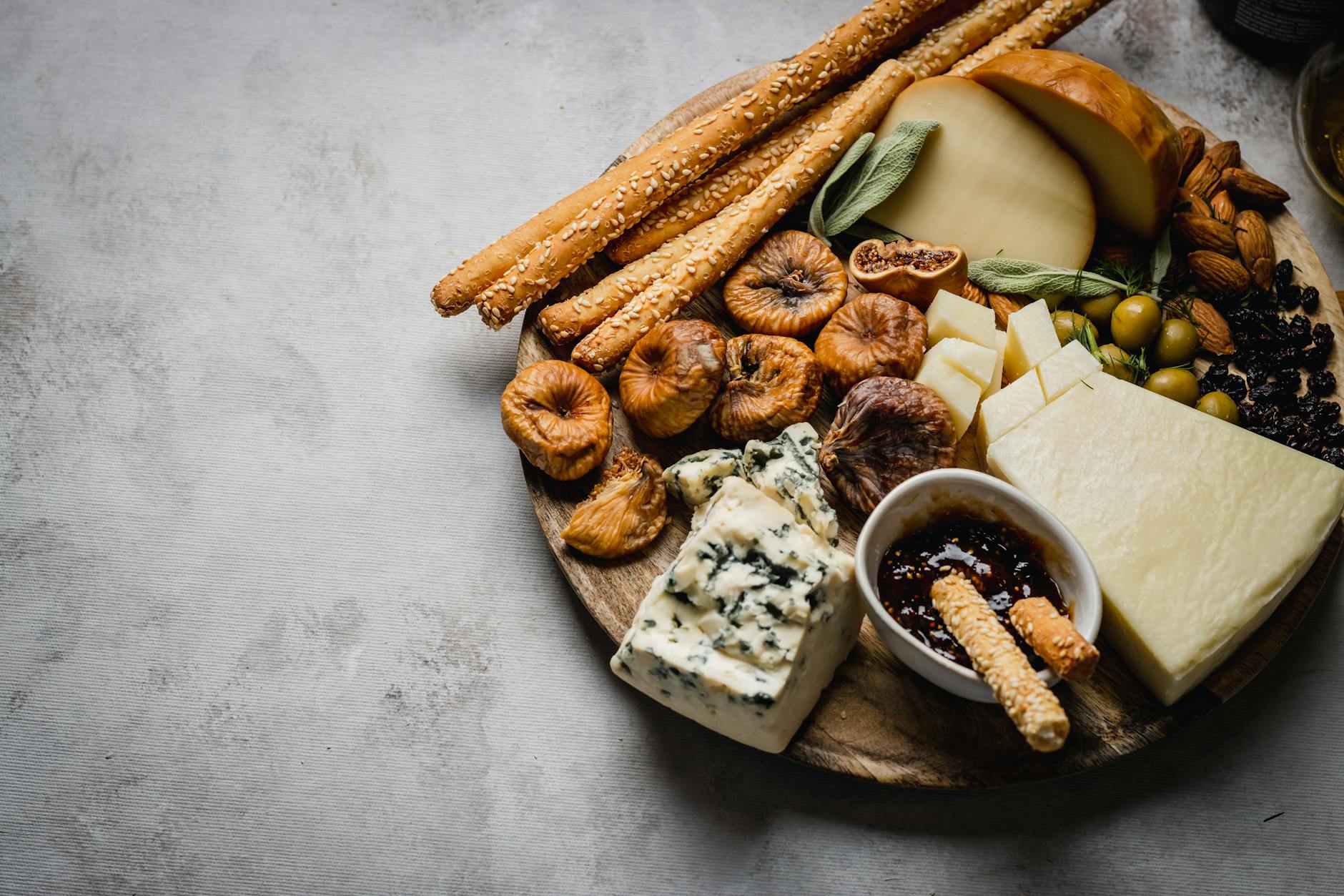 Cheese Platter With Assorted Cheese Varieties, Nuts, And Dried Fruits