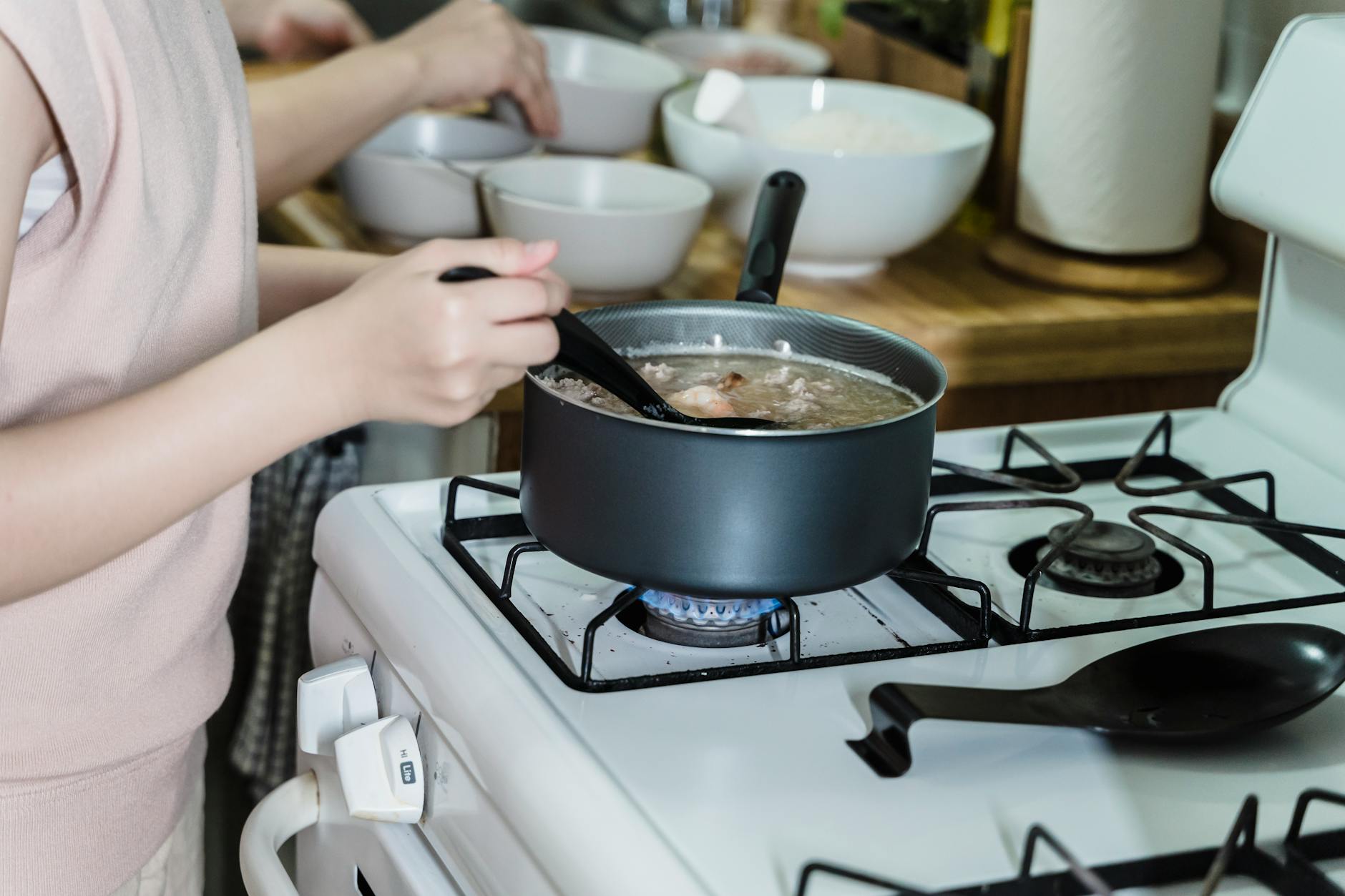 Cozy Kitchen With Warm Lighting And A Pot Of Soup On The Stove