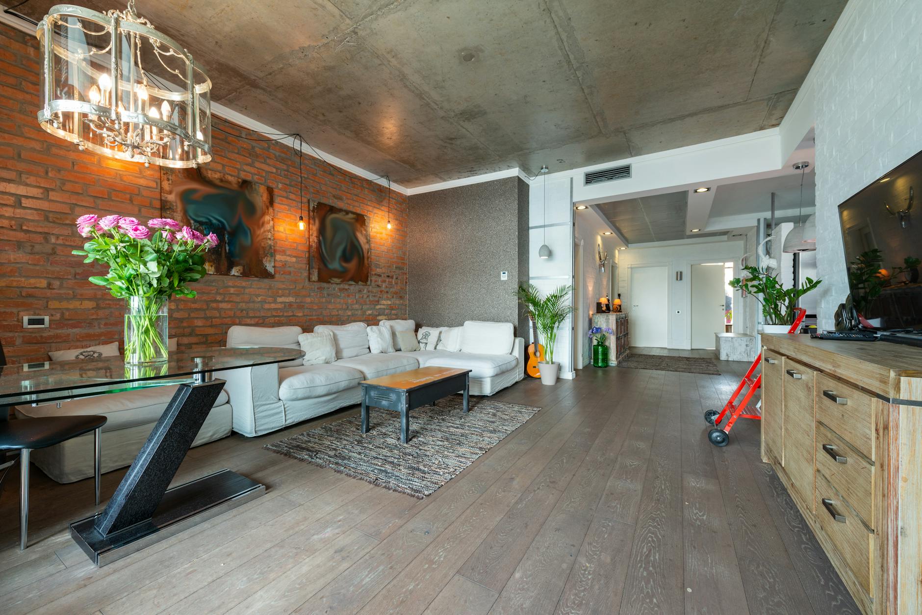 Concrete Look Accent Wall Paint In A Modern Loft Interior With Warm Lighting And Textured Decor