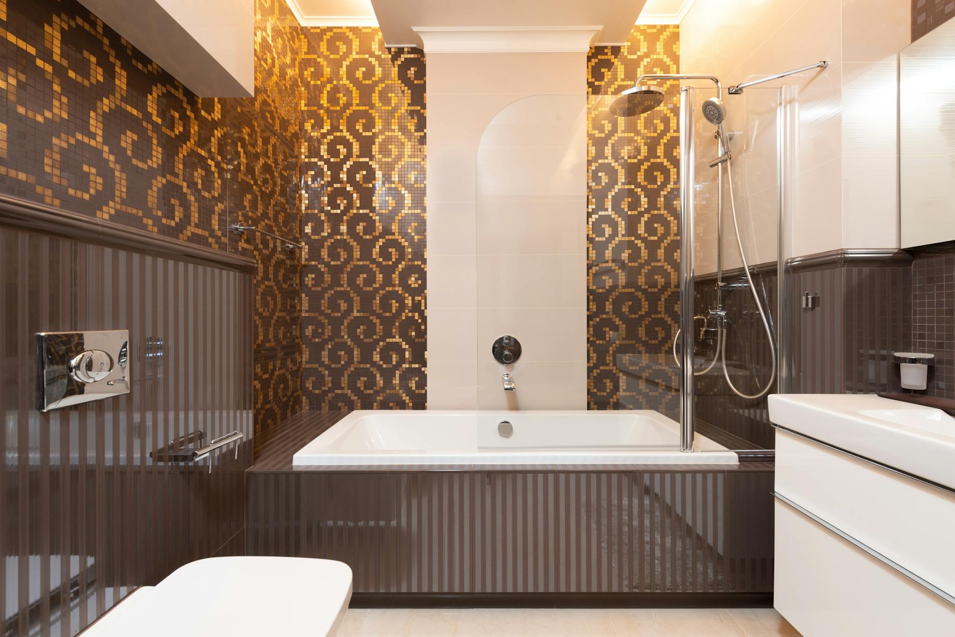 Metallic Gold Bathroom Tiles With Accents And Inserts In A Neutral Bathroom Setting