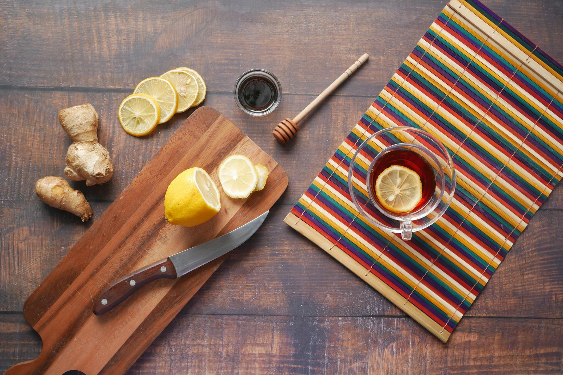 Ginger Root On A Wooden Cutting Board With A Knife And Fresh Tea Ingredients