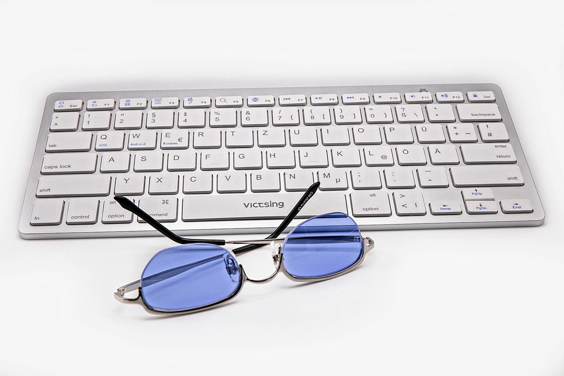 Blue Light Blocking Glasses On A Desk With A Computer And Office Supplies