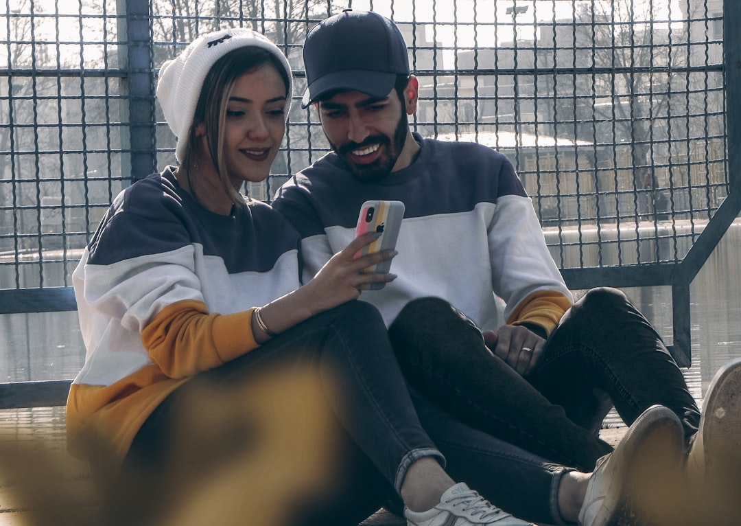 Couple Using Phone During Conversation