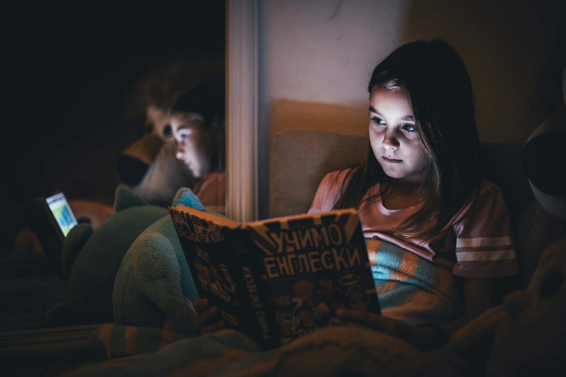 Children Reading In Dim Light