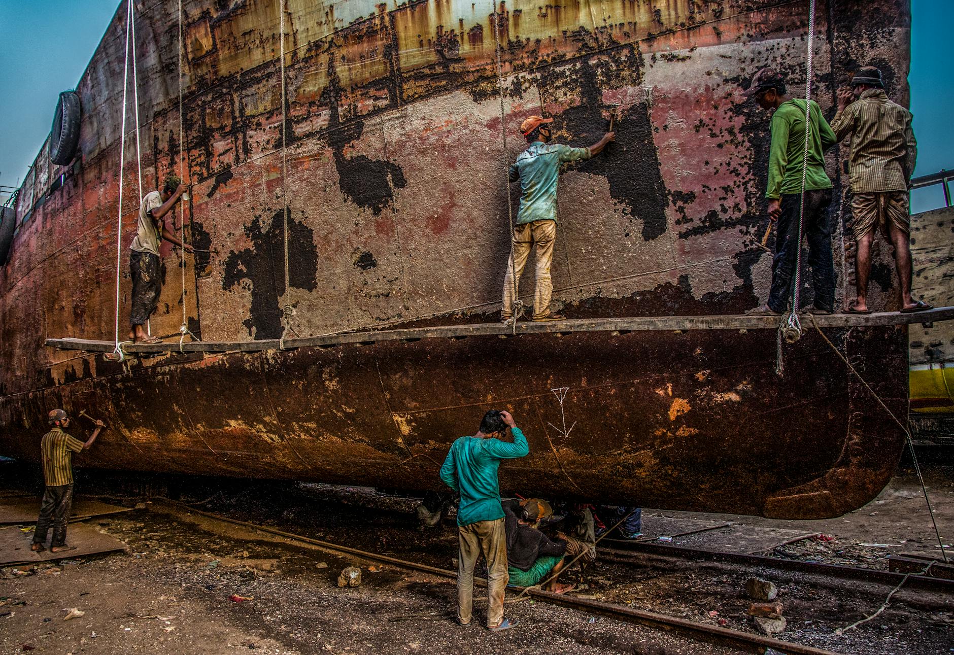 Worker Scraping Paint