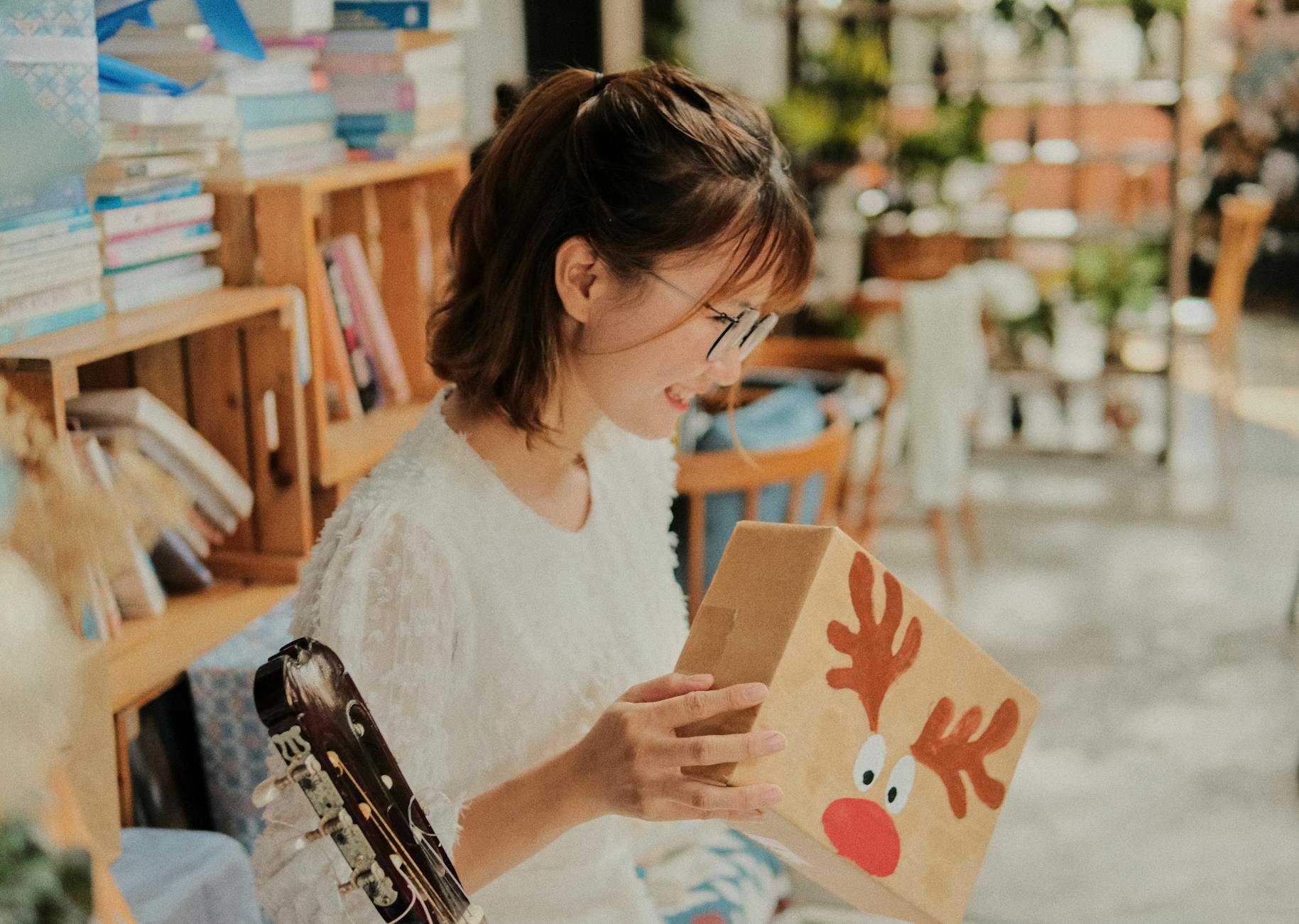 Hidden Christmas Presents Behind Books On Bookshelf