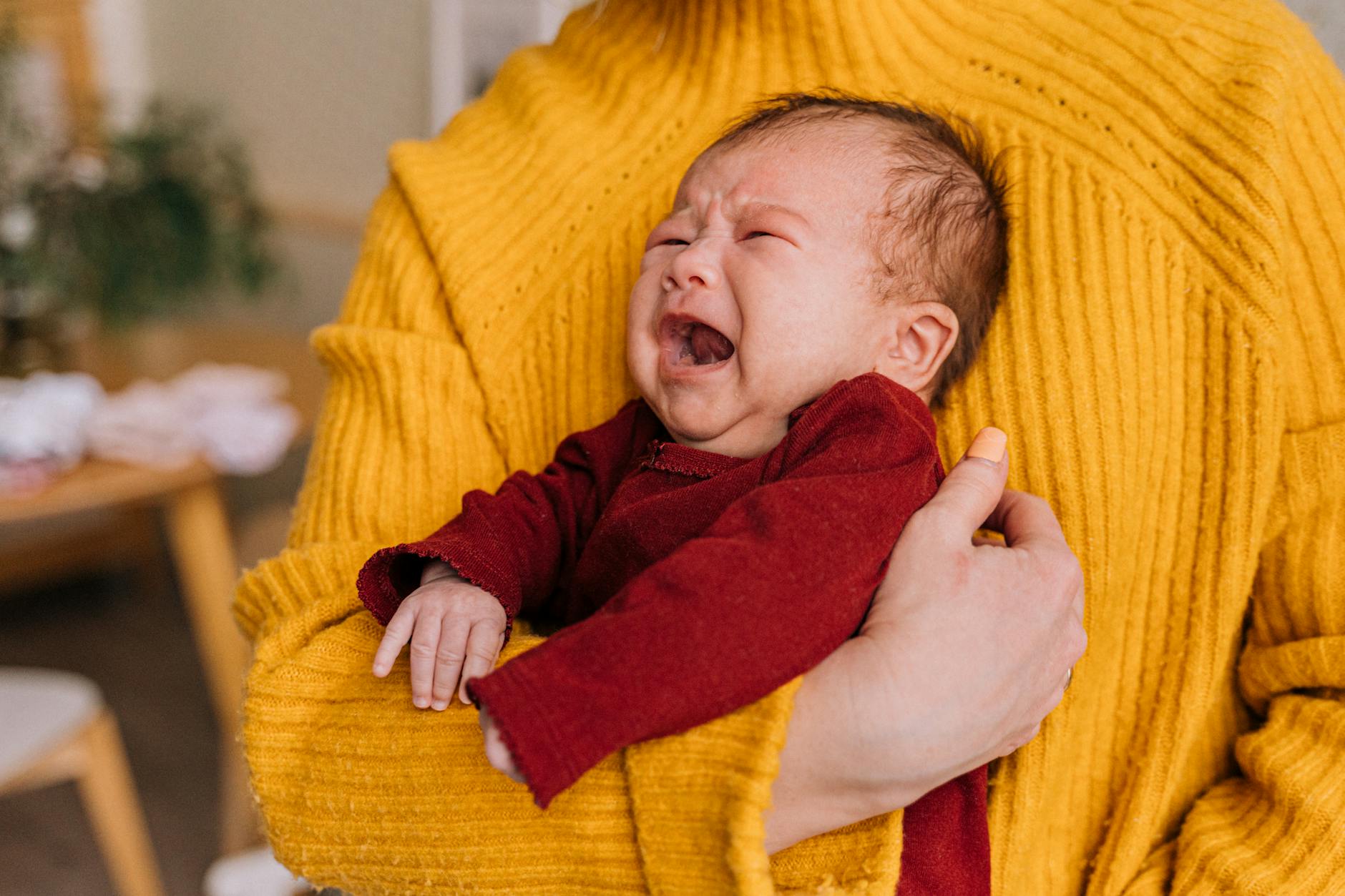 Crying Newborn With Caregiver