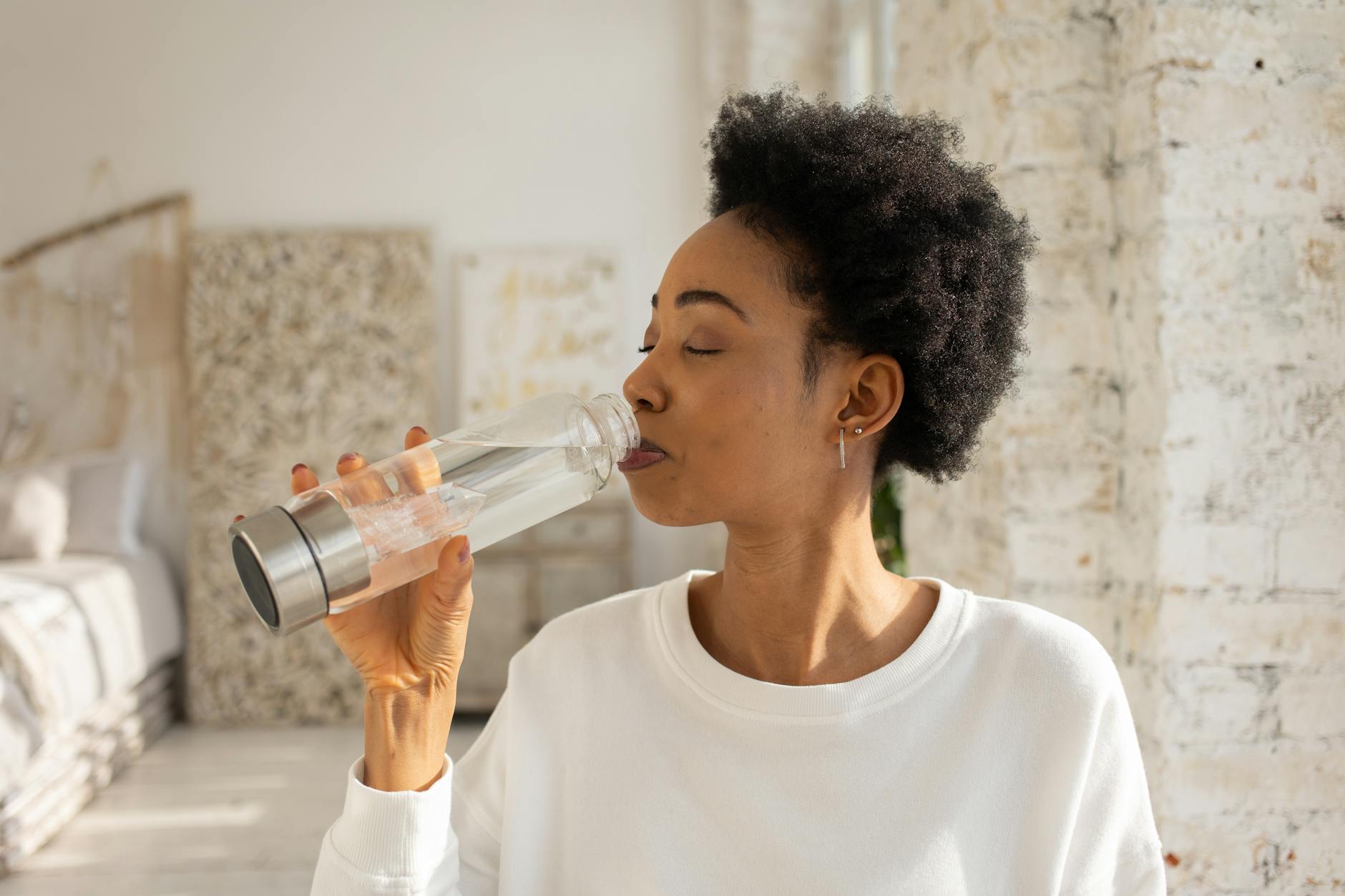 Black Woman Drinking Water For Hair Health