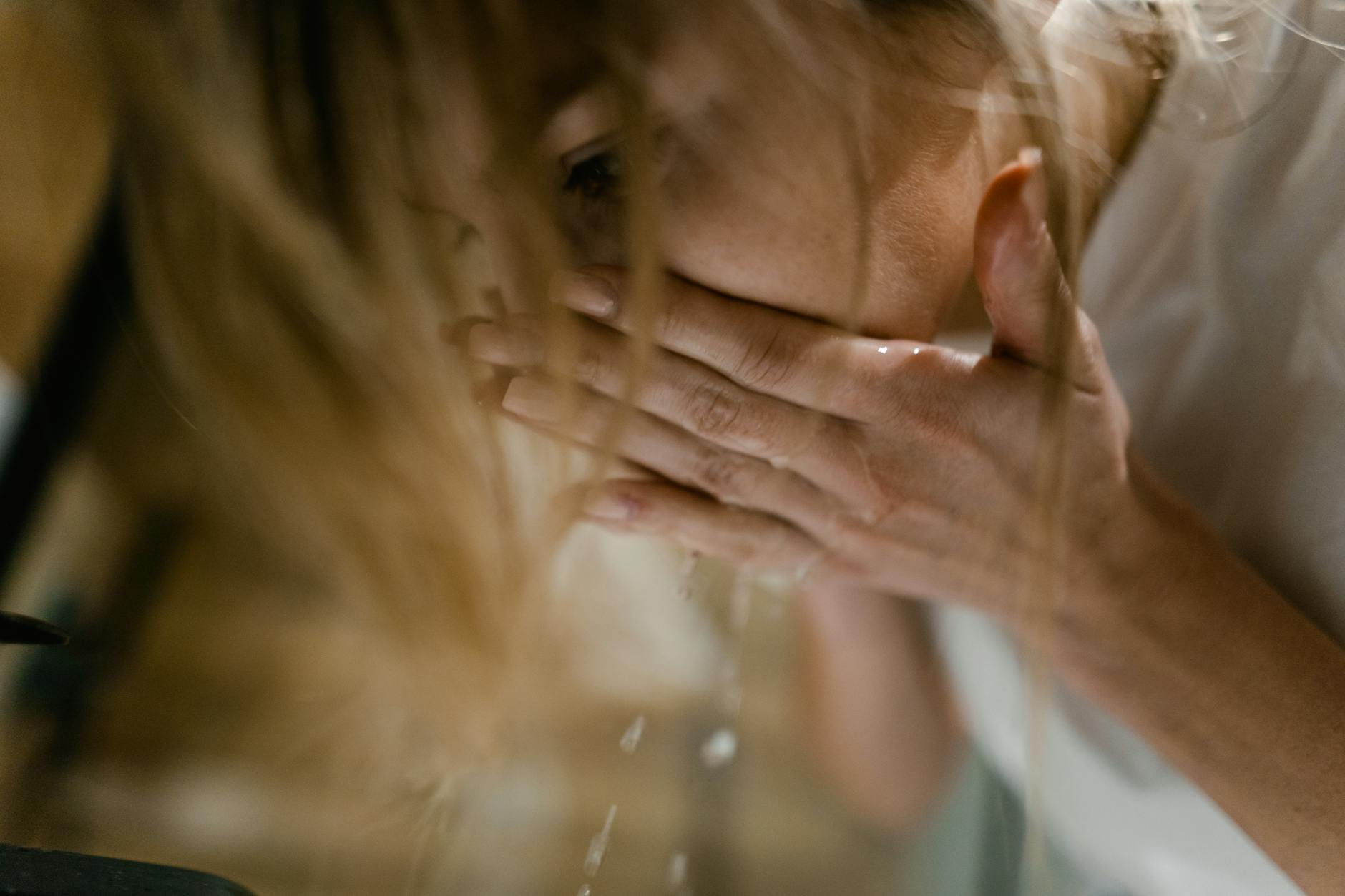 Woman Washing Face With Lukewarm Water