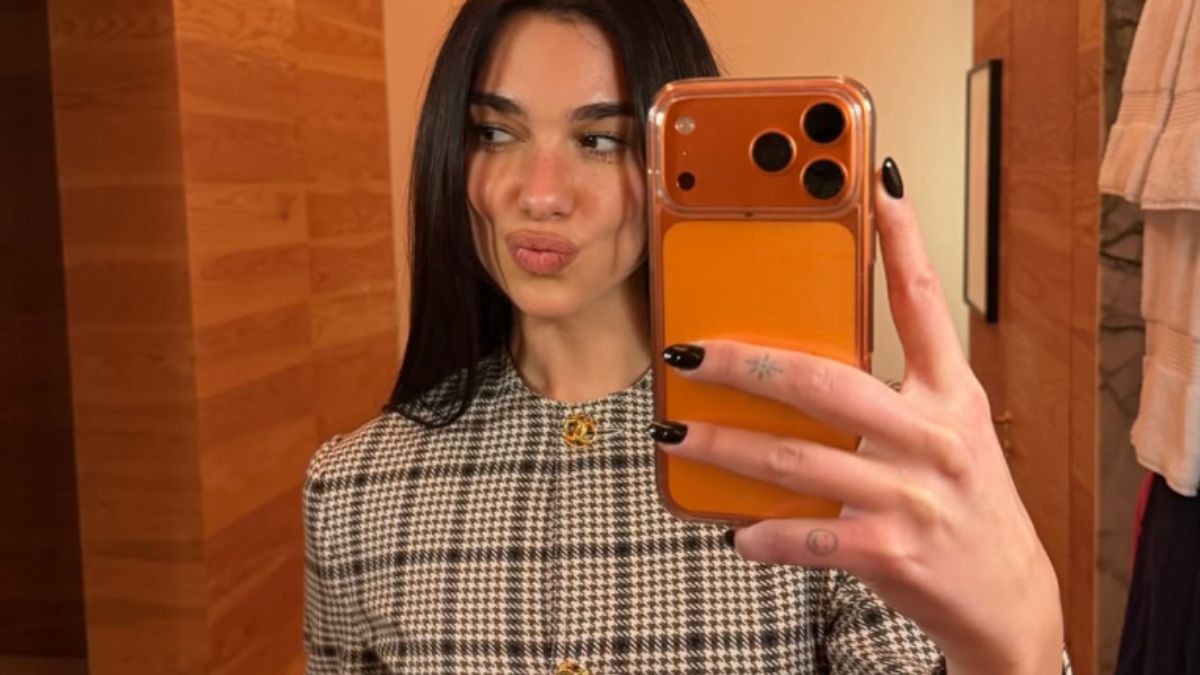 Dua Lipa’s Black Schiaparelli Gown with Gold Fringe Is the Vanity Fair Oscars Party Look We’re Still Thinking About