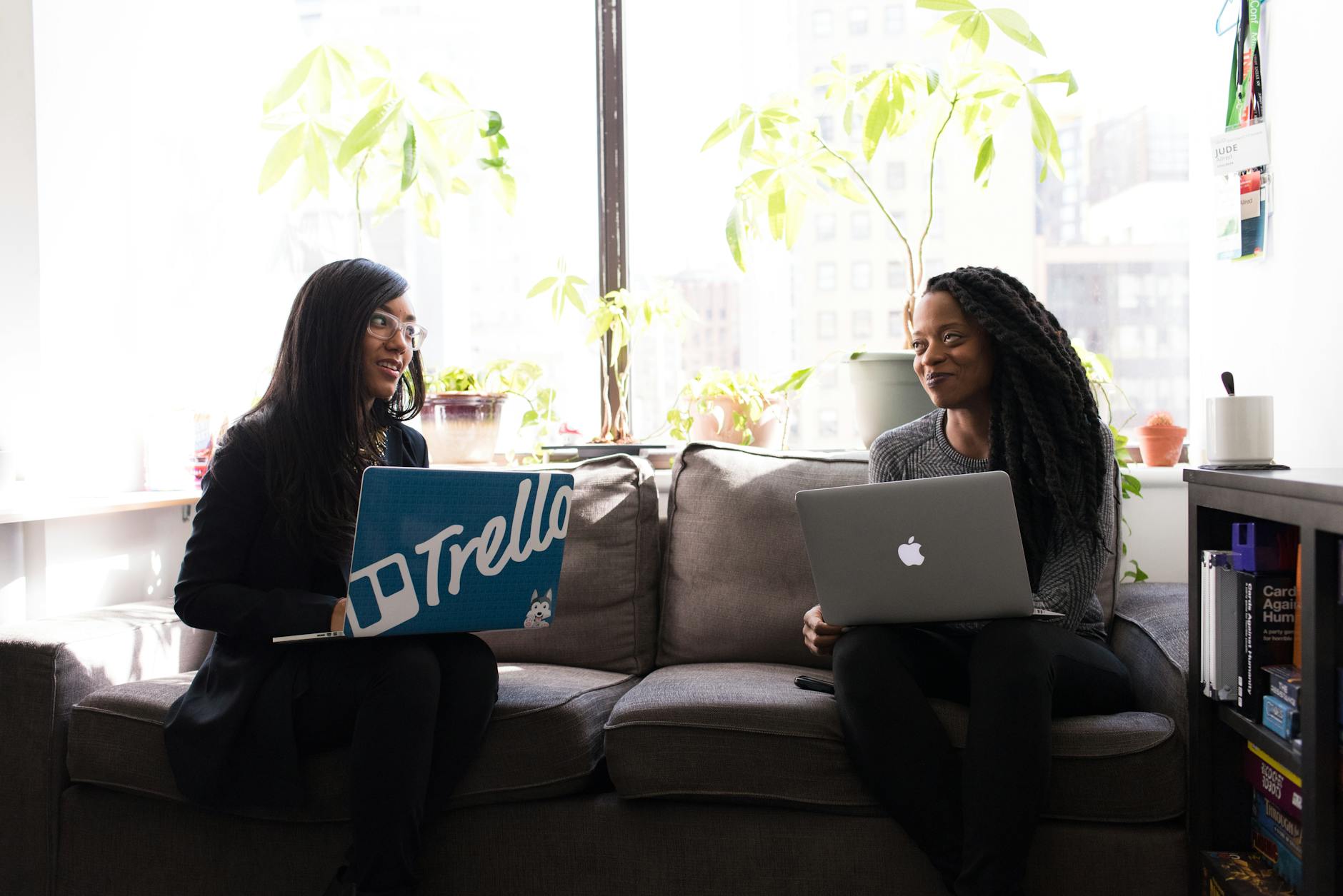 women on sofa with laptop