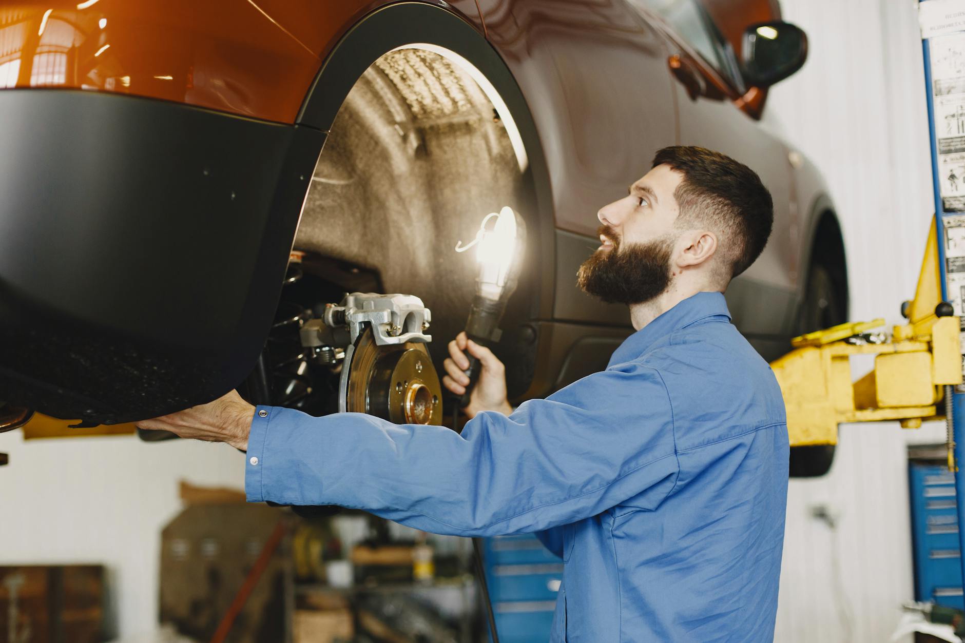 Mechanic Inspecting Vehicle
